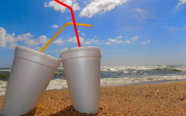 Two polystyrene cups on a beach